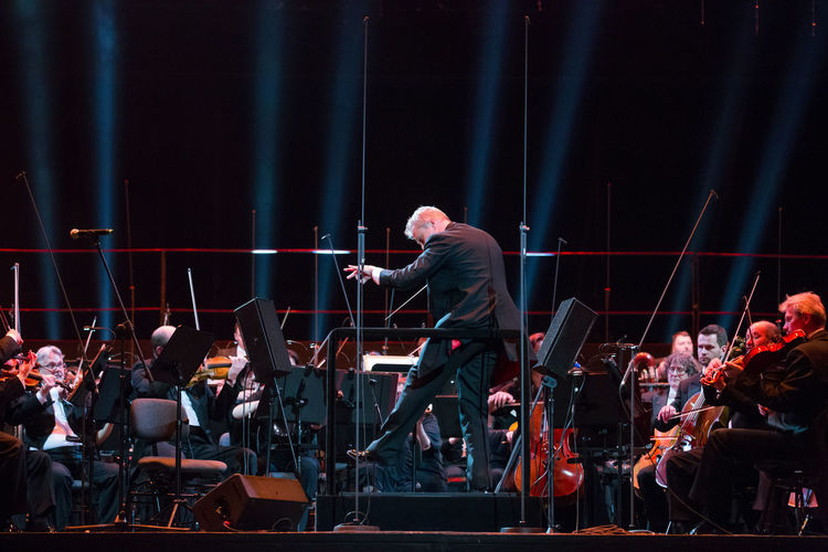 Men playing musical equipment on stage