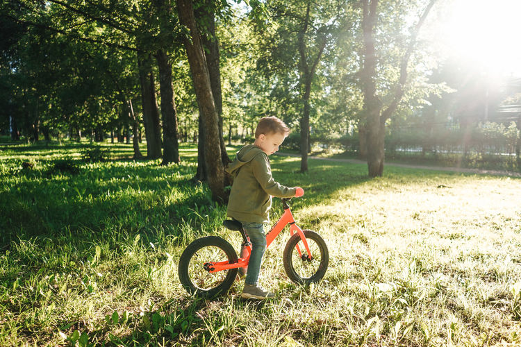 Portrait of boy riding bicycle on field