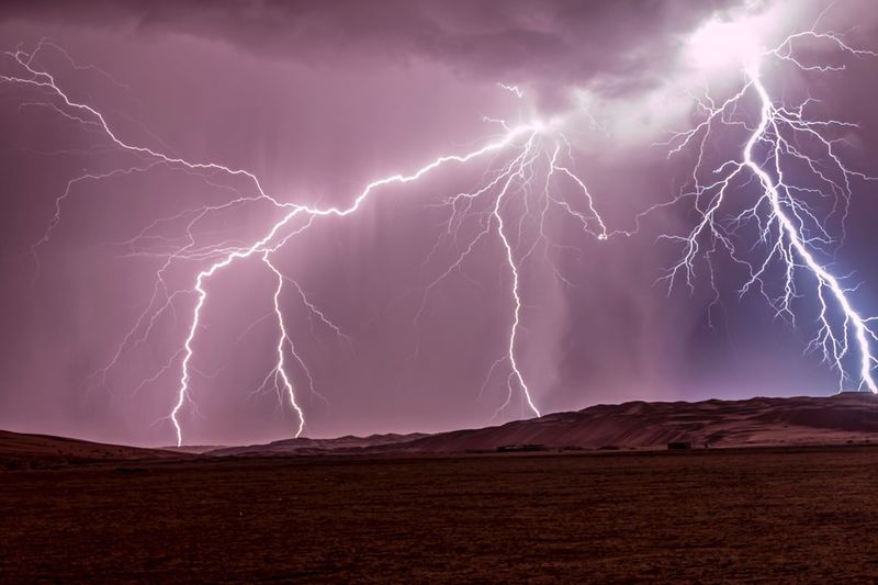 Lightning over desert against sky at night
