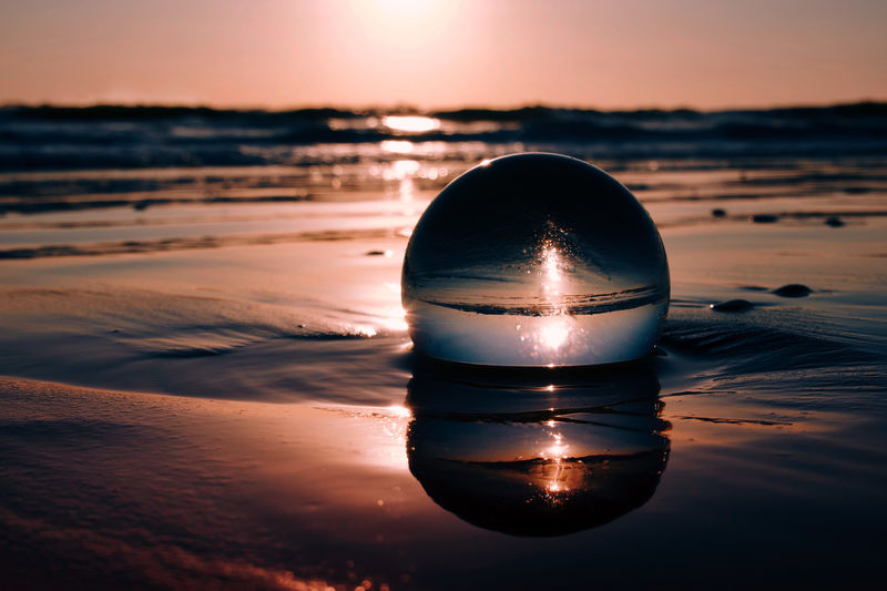 Crystal ball on the beach during sunrise 