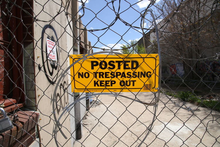 No trespassing sign on chainlink fence