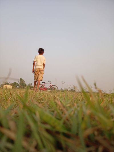 Boy golf practice in field.