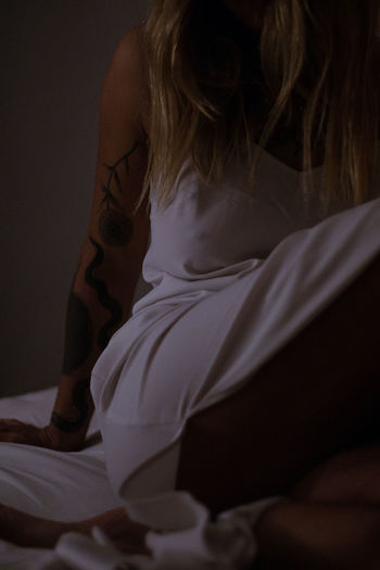 Rear view of woman sitting at home