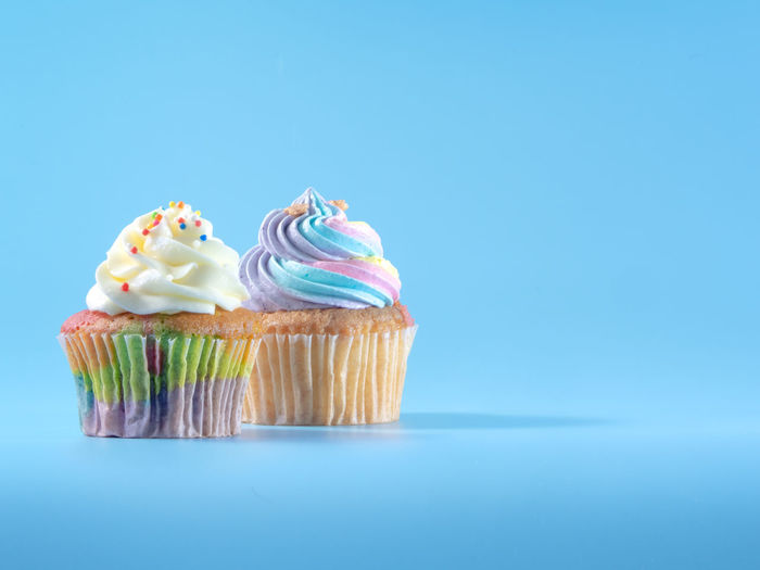 High angle view of cupcakes against blue background