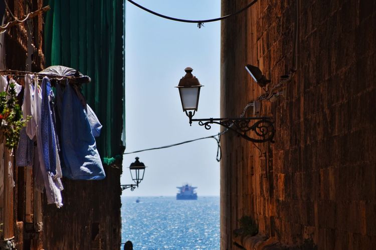 Low angle view of clothes hanging on wall by street