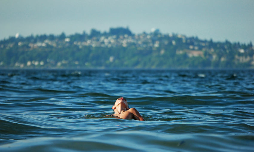Boy swimming in sea