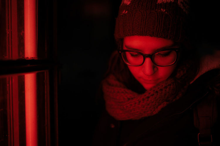 Portrait of woman wearing hat with red lights
