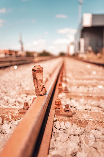 Close-up of rusty spray can on railroad track