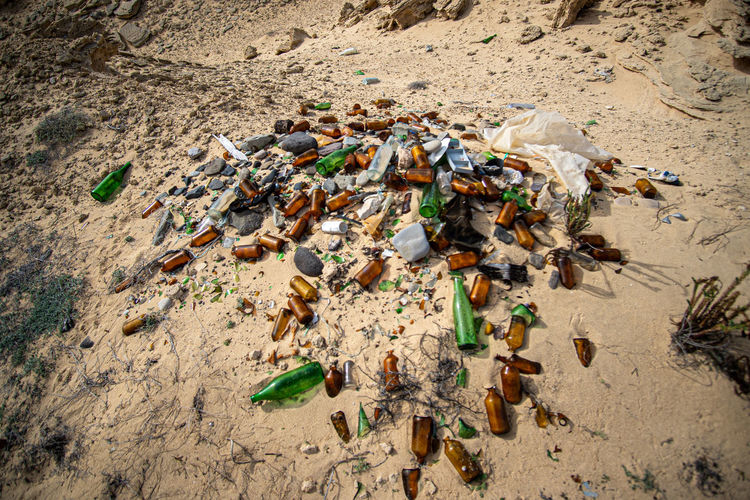 HIGH ANGLE VIEW OF GARBAGE ON SHORE