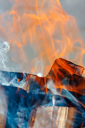 Smoke and fire from burning logs. close up. vertical photo