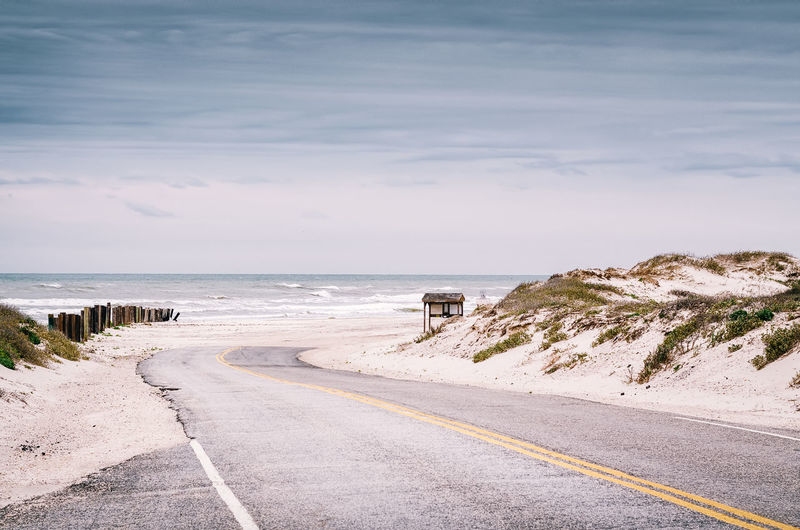 Empty road along sandy landscape