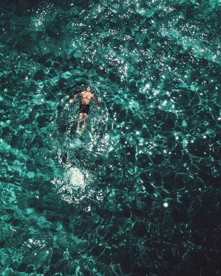 High angle view of man swimming on sea