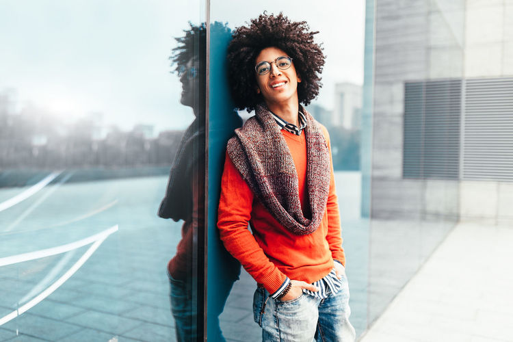 Handsome man in the big city Lifestyle Millenials Student Student Life Architecture Beautiful Woman Casual Clothing City Curly Hair Emotion Hair Hairstyle Leisure Activity Lifestyles Looking Away One Person Outdoors Portrait Real People Smile Smiling Standing Three Quarter Length Young Adult Young Women