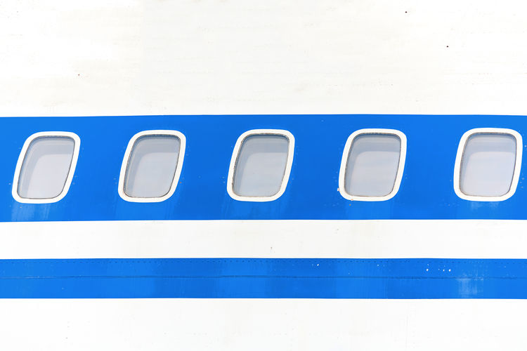 Close-up of airplane against blue wall
