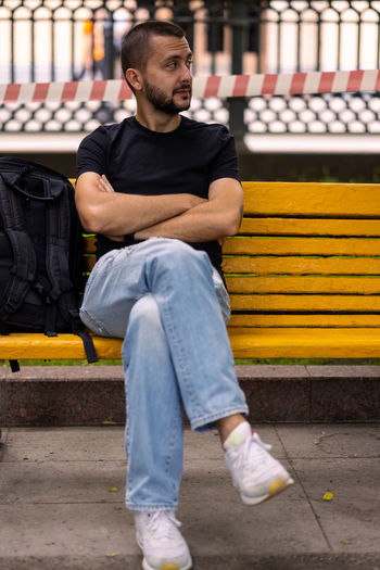 Low section of man sitting on chair