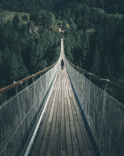 Girl with camera in the hands walking over a suspension bridge in Wallis, Switzerland Bellwald Bridge Bridge - Man Made Structure Bridges Building Bridges Built Structure Connection Crossing Bridges Discover Your City Explore Explorer Exploring Girl Girl On Bridge Girl With Camera Hängebrücke Nature Outdoors Photographer Suspension Bridge Switzerland Tree Valais Wallis Woman Traveling Home For The Holidays