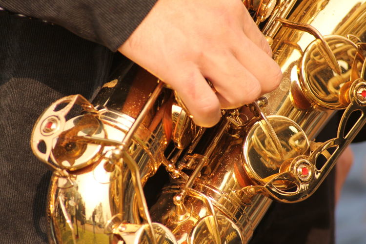 Close-up of person playing saxophone