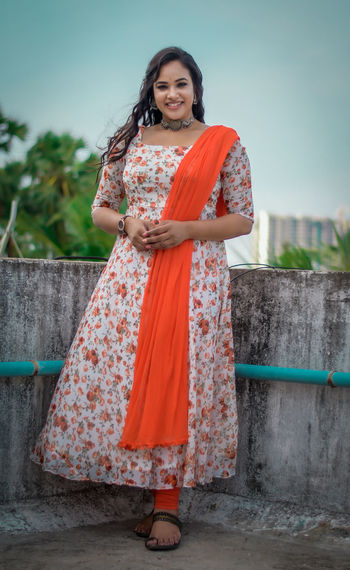 Portrait of woman standing against wall