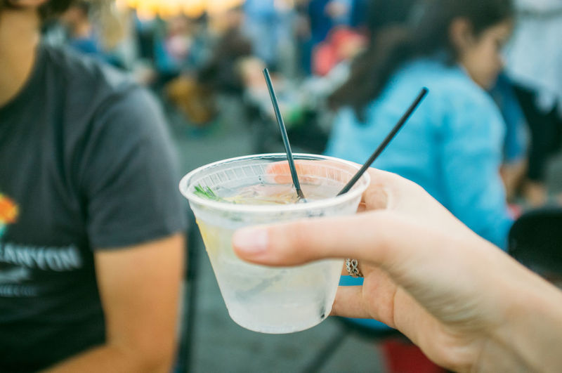 Cropped image of woman holding gin tonic cocktail
