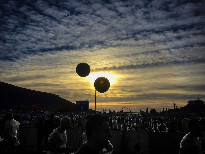 Silhouette of hot air balloons against sky at sunset