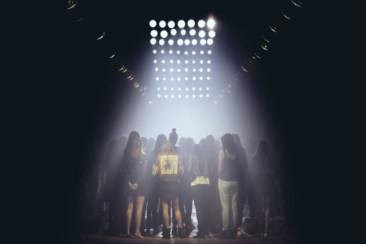 Rear view of women at backstage during fashion show