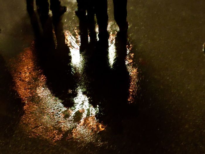 Low section of people standing on tiled floor