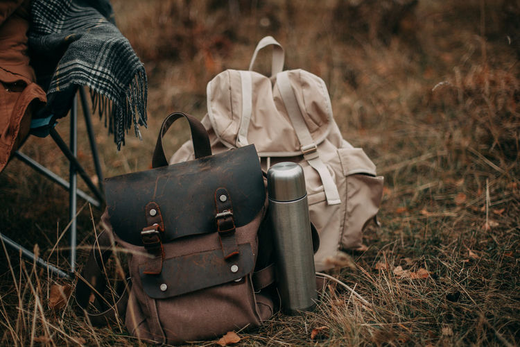 Two hiking backpacks and a thermos with tea at the camping