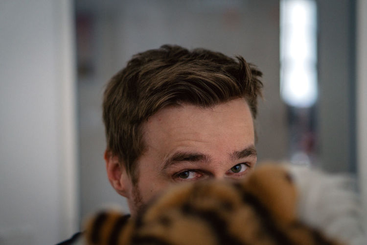 Close-up portrait of young man at home