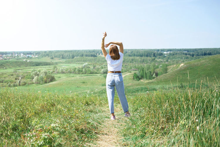 Field landscape, freedom and relax  concept, summer and spring. woman casual wear, enjoying travel. 
