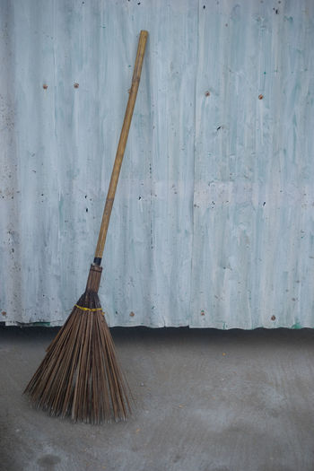 Broom against corrugated iron