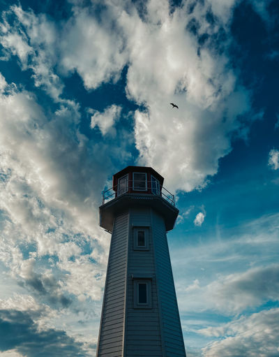 Low angle view of building and lighthouse against sky