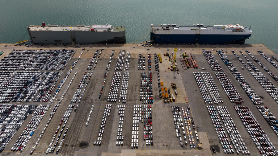 Aerial view new cars lined up in the port for exporting to dealership for sale, 