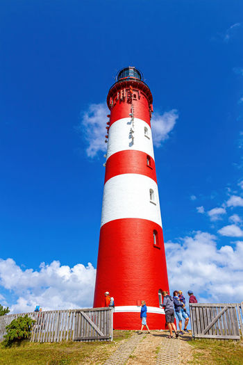 Low angle view of lighthouse against building against sky