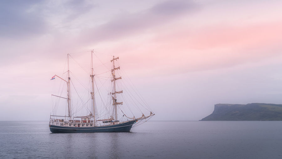 Beautiful tall ship anchored near northern ireland coast, covered in haze, ballycastle
