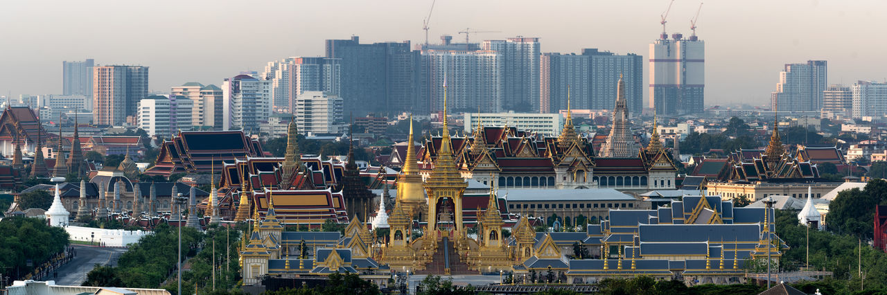 Aerial view of buildings in city against sky