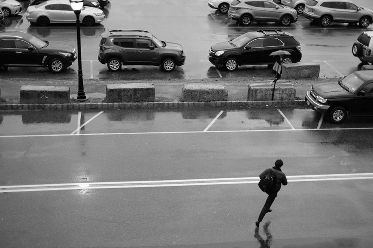 People on wet street in city during rainy season
