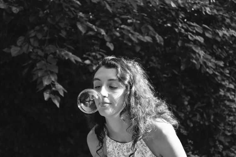 Portrait of beautiful young woman with bubbles