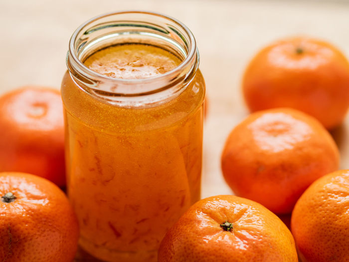 Close-up of oranges in jar on table