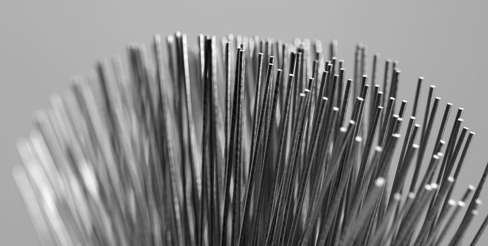 Close-up of metallic wire against gray background