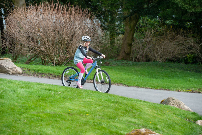 Man riding bicycle on grassland