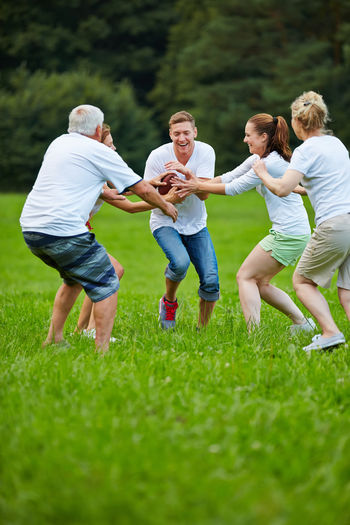 Family playing on grassy field