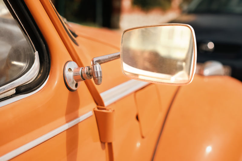 Photo of a mirror and parts of an old classic car, selective focus, idea for a picture or postcard