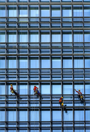 People working in glass building