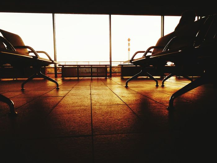 Empty seats in airport against clear sky