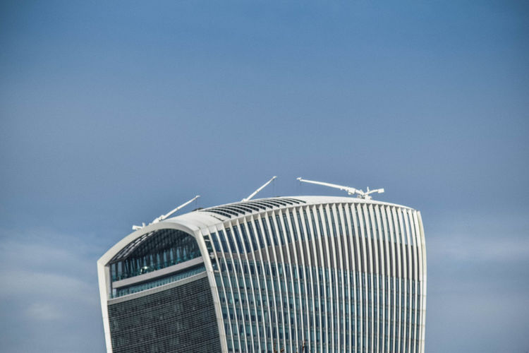 Low angle view of walkie-talkie building, london, against blue sky with copy space 