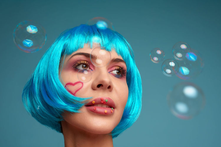 Woman with dyed hair looking away