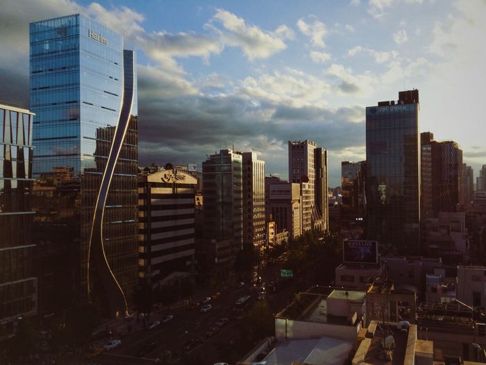 City skyline against cloudy sky