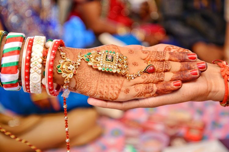 Cropped hands of bride and groom during wedding ceremony