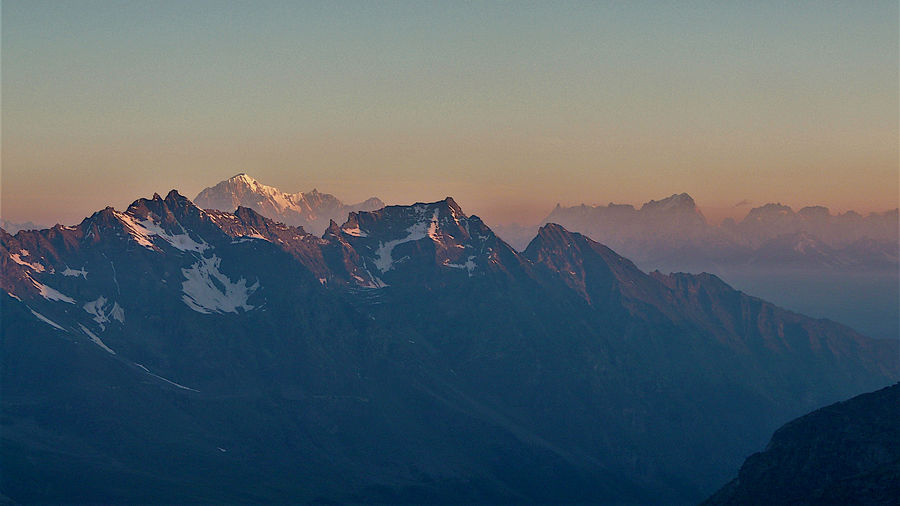 Scenic view of snowcapped mountains against sky during sunset