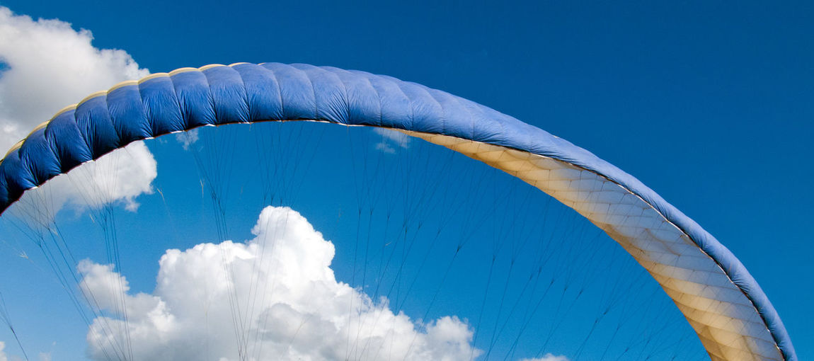 Low angle view of parachute against sky